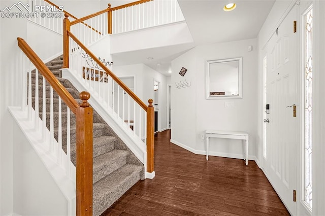 entryway featuring recessed lighting, stairway, baseboards, and wood finished floors