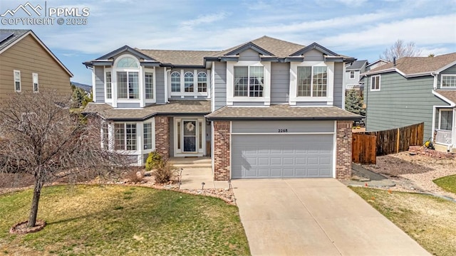 traditional-style home featuring brick siding, an attached garage, fence, and driveway