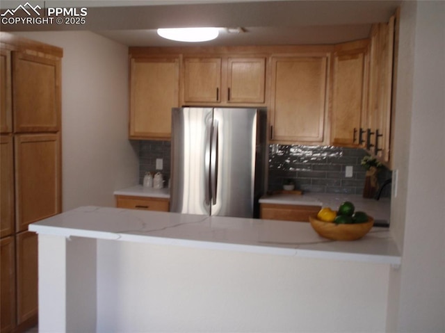2112 Denton Grv Unit 101, Colorado Springs, CO 80919 - kitchen featuring freestanding refrigerator, light countertops, and backsplash