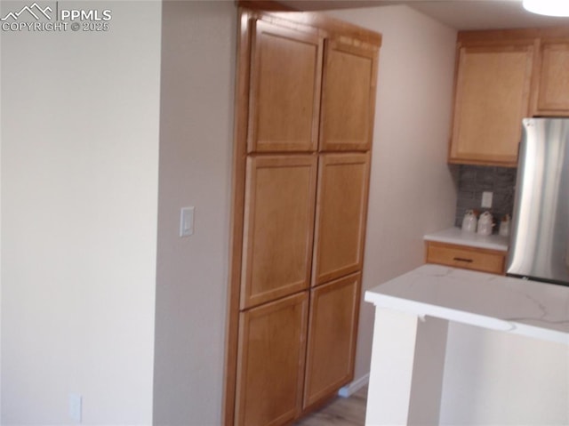2112 Denton Grv Unit 101, Colorado Springs, CO 80919 - kitchen featuring freestanding refrigerator and backsplash
