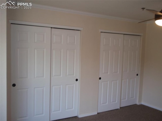2112 Denton Grv Unit 101, Colorado Springs, CO 80919 - unfurnished bedroom featuring dark carpet, two closets, and ornamental molding