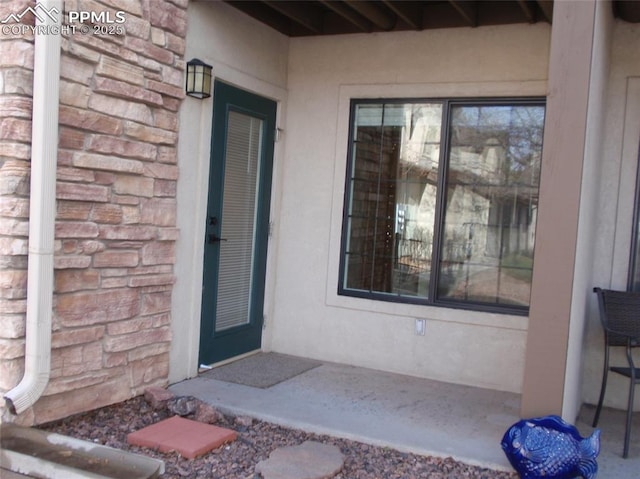 2112 Denton Grv Unit 101, Colorado Springs, CO 80919 - doorway to property with stone siding and stucco siding