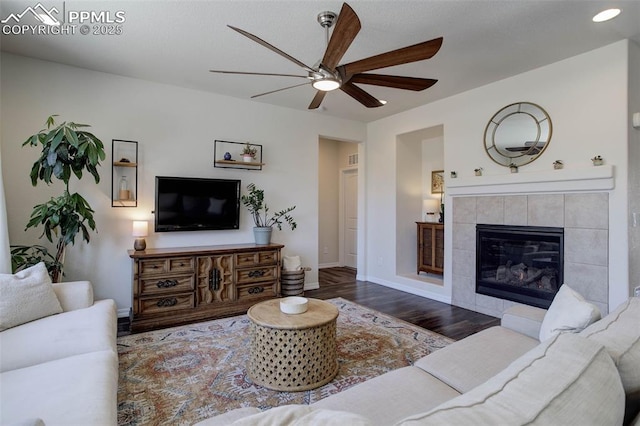 17718 Leisure Lake Dr, Monument, CO 80132 - living room featuring a ceiling fan, wood finished floors, baseboards, and a fireplace