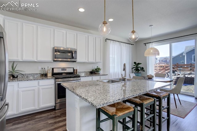 17718 Leisure Lake Dr, Monument, CO 80132 - kitchen with appliances with stainless steel finishes, a sink, dark wood-type flooring, white cabinets, and recessed lighting