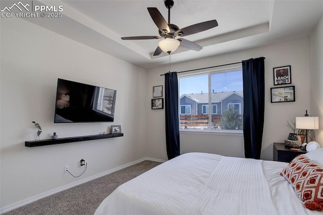 17718 Leisure Lake Dr, Monument, CO 80132 - bedroom featuring carpet, a tray ceiling, baseboards, and ceiling fan