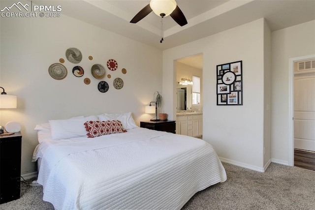 17718 Leisure Lake Dr, Monument, CO 80132 - bedroom featuring baseboards, carpet, ensuite bath, a ceiling fan, and a tray ceiling