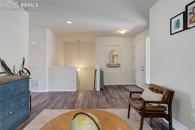 17718 Leisure Lake Dr, Monument, CO 80132 - sitting room with an upstairs landing, wood finished floors, baseboards, and recessed lighting