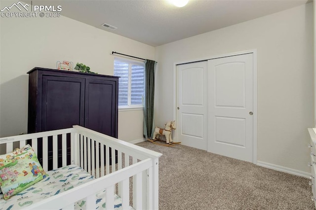 17718 Leisure Lake Dr, Monument, CO 80132 - bedroom with carpet flooring, a closet, baseboards, and a crib
