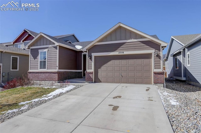 17718 Leisure Lake Dr, Monument, CO 80132 - view of front of house featuring board and batten siding, brick siding, a garage, and driveway