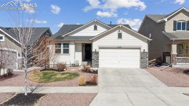 view of front facade with driveway, an attached garage, and stone siding