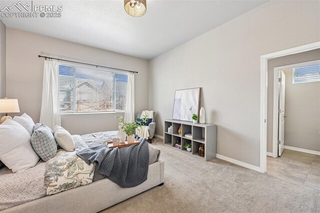 carpeted bedroom featuring baseboards