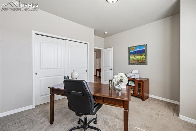 office space with light carpet and baseboards