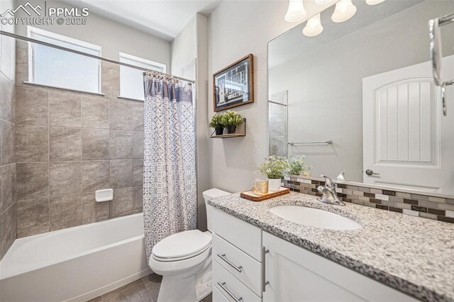 full bathroom with toilet, tile patterned floors, vanity, tasteful backsplash, and shower / tub combo