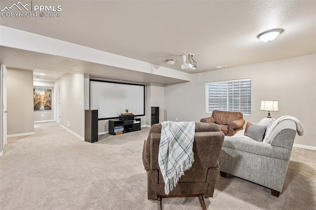 home theater featuring baseboards, carpet flooring, and a textured ceiling