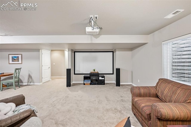 carpeted cinema with baseboards and visible vents