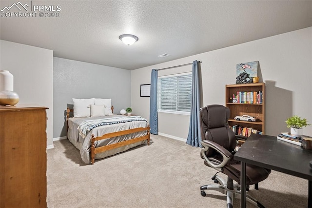 bedroom featuring carpet, baseboards, and a textured ceiling
