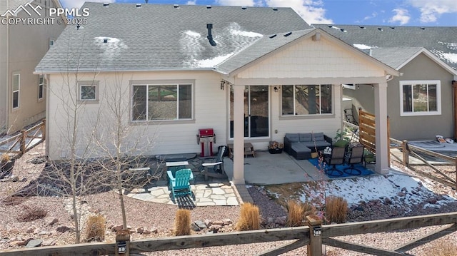 back of property featuring fence, roof with shingles, and a patio area