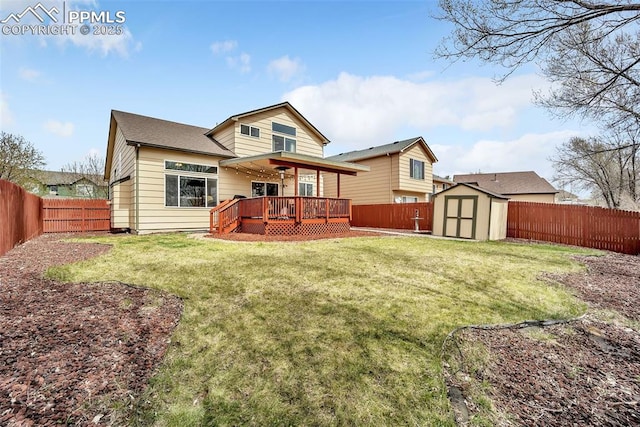 back of property with a fenced backyard, a deck, an outdoor structure, a yard, and a shed