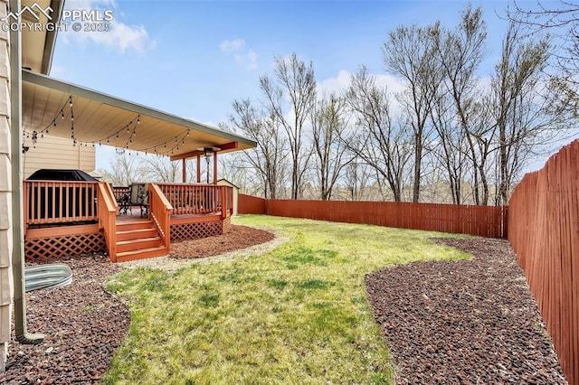 view of yard with a fenced backyard and a deck