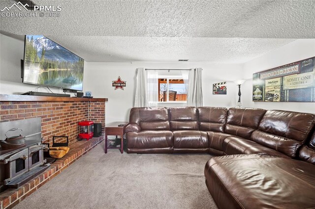 carpeted living room featuring a textured ceiling and a wood stove
