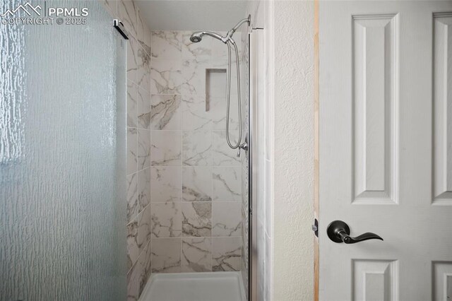 full bath with a shower stall