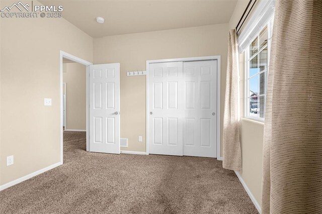 9712 Wando Dr, Colorado Springs, CO 80925 - unfurnished bedroom featuring baseboards, a closet, and carpet
