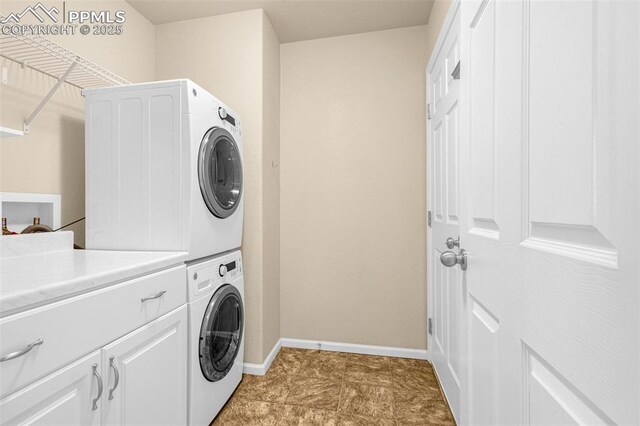 9712 Wando Dr, Colorado Springs, CO 80925 - laundry room with stacked washer and dryer, cabinet space, and baseboards