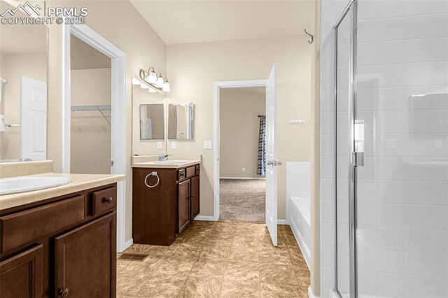 9712 Wando Dr, Colorado Springs, CO 80925 - full bathroom with two vanities, a sink, and a stall shower