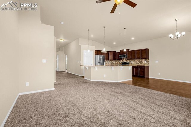 9712 Wando Dr, Colorado Springs, CO 80925 - kitchen with light countertops, tasteful backsplash, appliances with stainless steel finishes, open floor plan, and a kitchen island with sink