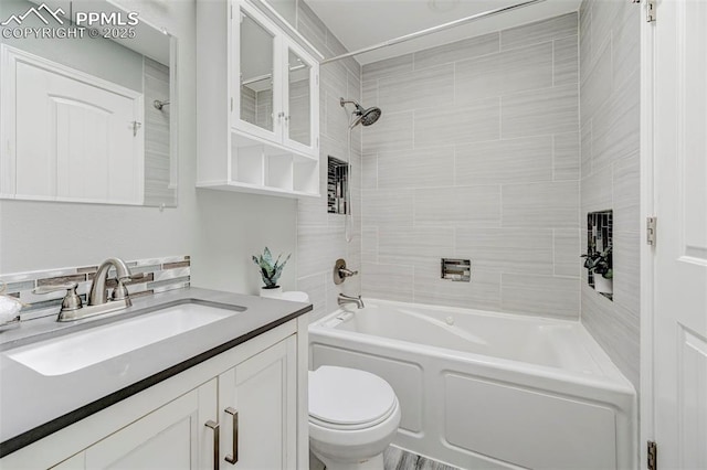 bathroom with toilet, vanity, and shower / bathtub combination