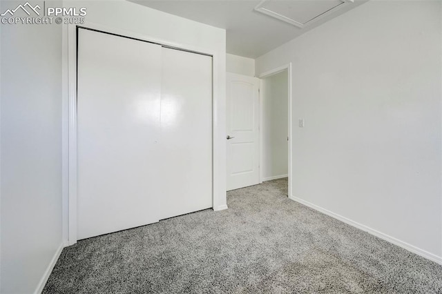 unfurnished bedroom with a closet, baseboards, and carpet flooring