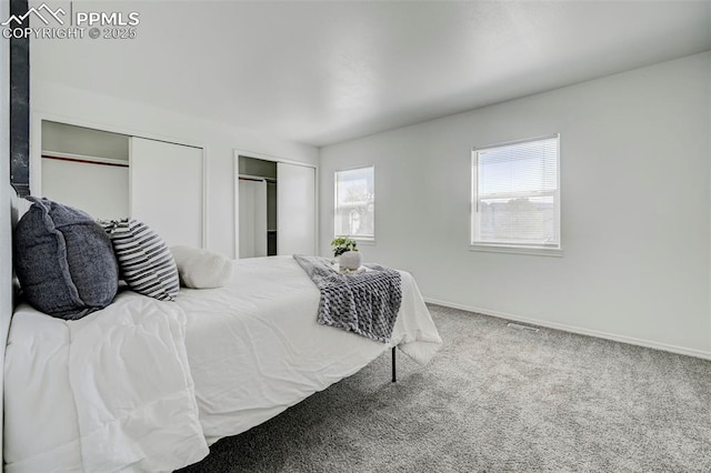 carpeted bedroom with baseboards and multiple closets