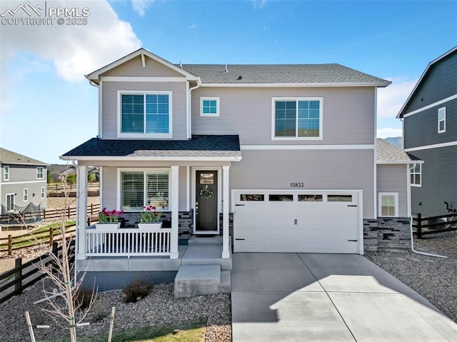 15833 Little Bluestem Rd, Monument, CO 80132 - view of front of home with a porch, roof with shingles, fence, an attached garage, and concrete driveway