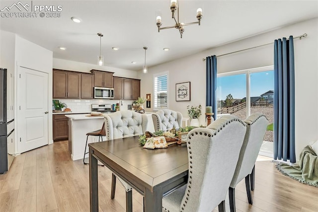 15833 Little Bluestem Rd, Monument, CO 80132 - dining space with a chandelier, light wood-style floors, and recessed lighting