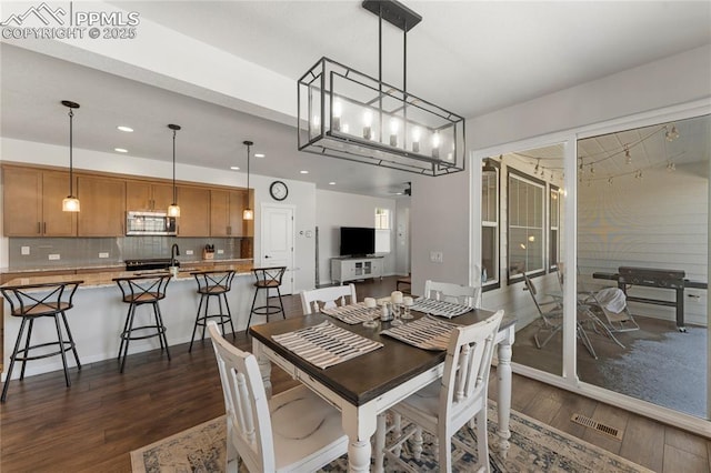 5894 Spring Breeze Dr, Colorado Springs, CO 80923 - dining space featuring recessed lighting, dark wood-style floors, and visible vents
