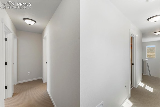 5894 Spring Breeze Dr, Colorado Springs, CO 80923 - hall with an upstairs landing, visible vents, baseboards, and carpet