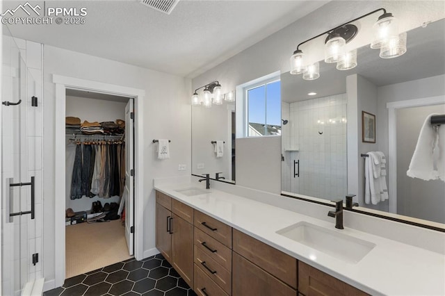5894 Spring Breeze Dr, Colorado Springs, CO 80923 - bathroom with a shower stall, double vanity, a sink, and visible vents
