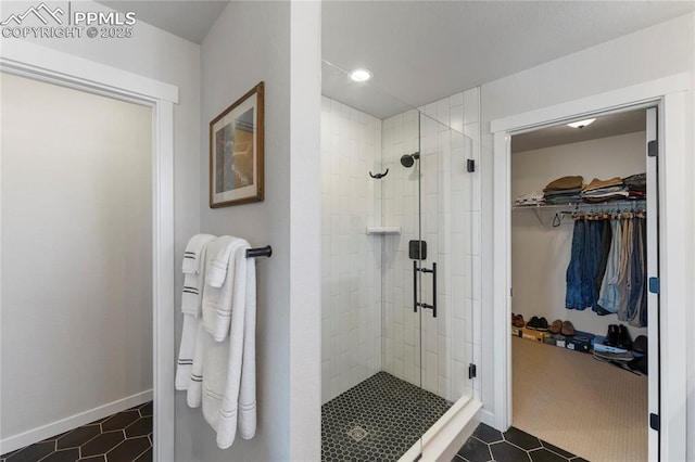 5894 Spring Breeze Dr, Colorado Springs, CO 80923 - bathroom featuring a walk in closet, tile patterned floors, baseboards, and a shower stall