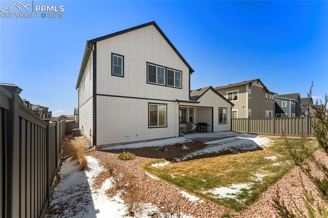 5894 Spring Breeze Dr, Colorado Springs, CO 80923 - rear view of property featuring a patio area, a fenced backyard, and board and batten siding