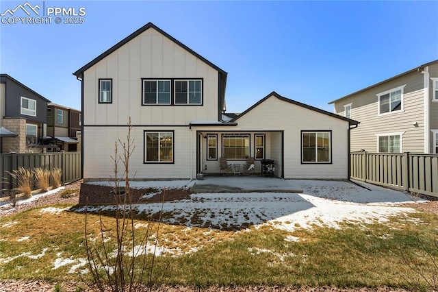 5894 Spring Breeze Dr, Colorado Springs, CO 80923 - snow covered house with a patio, board and batten siding, and fence