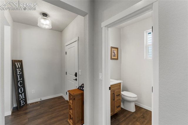 5894 Spring Breeze Dr, Colorado Springs, CO 80923 - interior space featuring toilet, baseboards, vanity, and wood finished floors