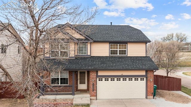 795 Ridgebury Pl, Fountain, CO 80817 - traditional-style home with fence, brick siding, an attached garage, a shingled roof, and driveway