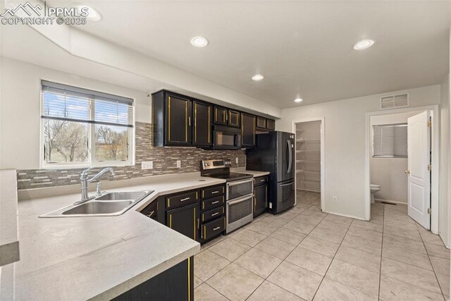 795 Ridgebury Pl, Fountain, CO 80817 - kitchen with visible vents, a sink, light countertops, appliances with stainless steel finishes, and backsplash