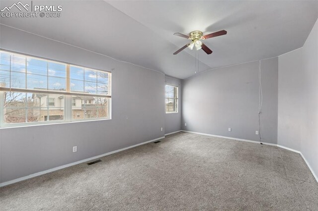 795 Ridgebury Pl, Fountain, CO 80817 - spare room featuring visible vents, baseboards, a ceiling fan, vaulted ceiling, and carpet flooring