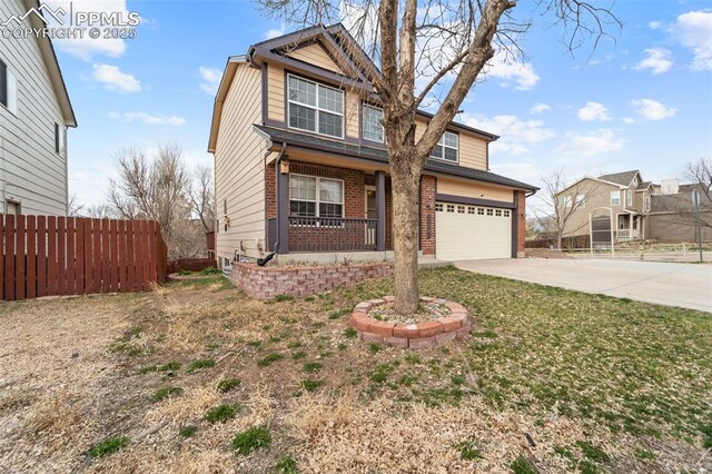 795 Ridgebury Pl, Fountain, CO 80817 - traditional-style house with brick siding, an attached garage, fence, and concrete driveway
