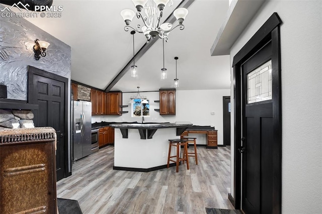 kitchen featuring open shelves, dark countertops, a kitchen breakfast bar, light wood-type flooring, and stainless steel fridge with ice dispenser