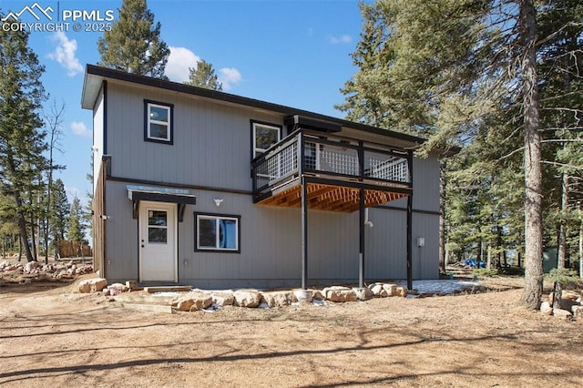 rear view of property featuring a balcony