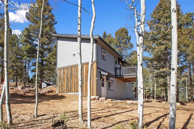 view of property exterior with a deck