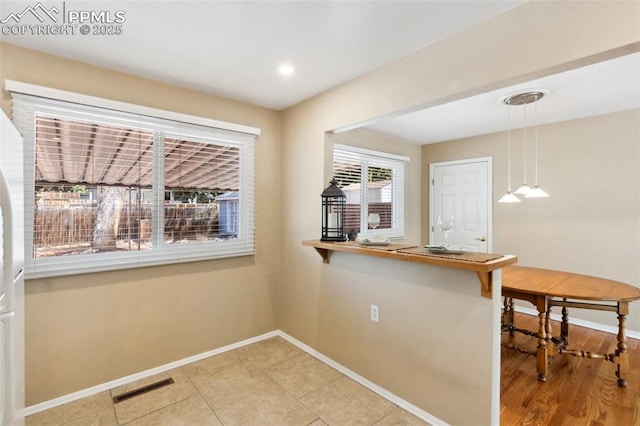 2928 Drakestone Dr, Colorado Springs, CO 80909 - unfurnished dining area with visible vents and baseboards