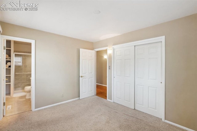 2928 Drakestone Dr, Colorado Springs, CO 80909 - unfurnished bedroom with a closet, connected bathroom, carpet, and baseboards